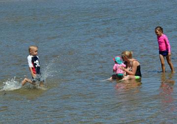 Mum and toddlers enjoying the safe beach