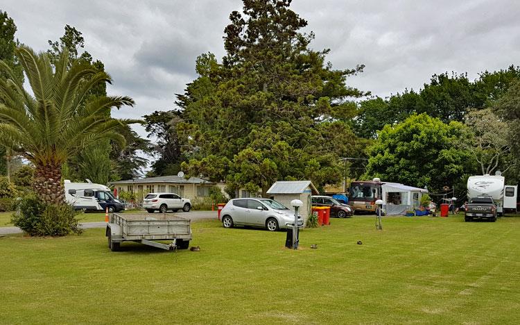 Campsite parking with the reception building in the distance