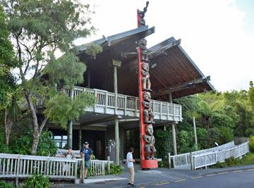 The main visitor centre building with Maori Pou outside