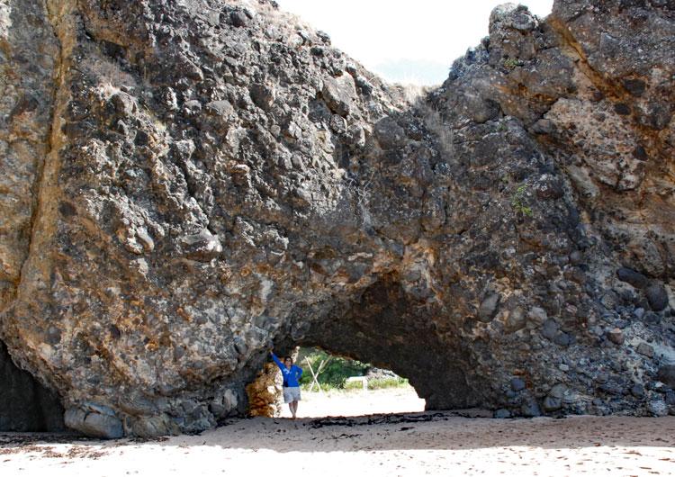 Rock archway leading to another bay