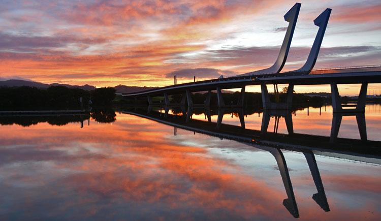 Reflections of a sunrise over the bridge