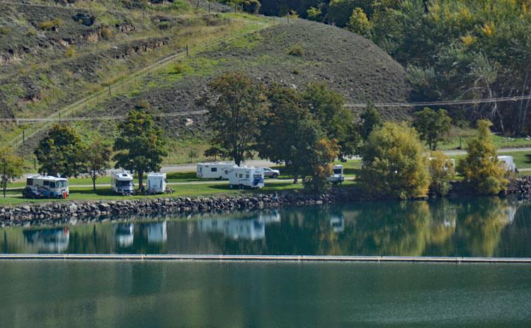 Motorhomes parked on the other side of the lake