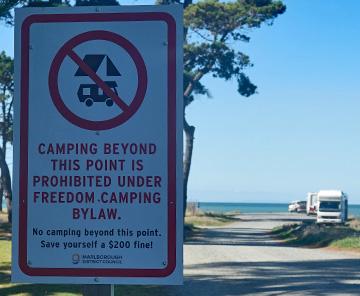 No beach camping sign