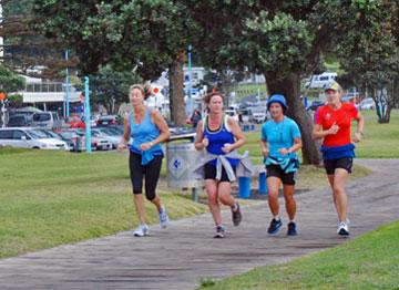 Joggers running along the boardwalk